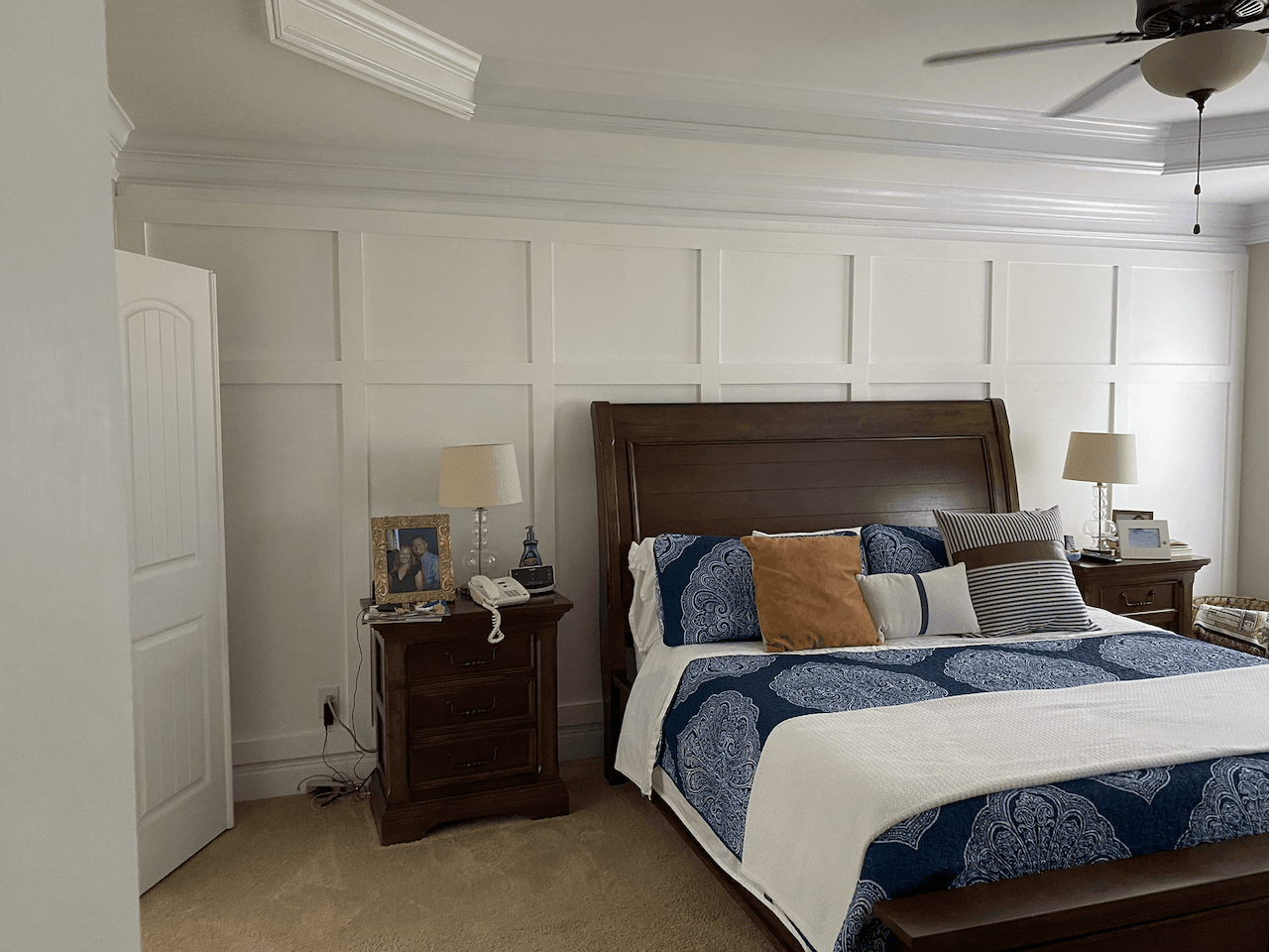 Bedroom with a fresh white board-and-batten accent wall and crown molding